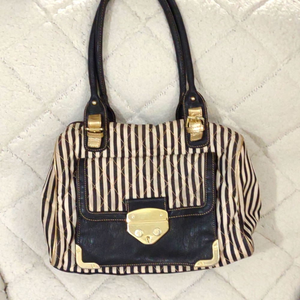 Black and white purse with gold accents.